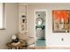 Stylish room featuring modern decor, a comfortable chair, and a glimpse of a bathroom at 11673 W 28Th Ave, Lakewood, CO 80215