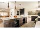 Spacious kitchen island with quartz countertops, dark wood cabinets, and open-concept living area at 11673 W 28Th Ave, Lakewood, CO 80215