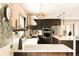 Spacious kitchen with an island, stainless steel appliances, custom cabinetry, and stylish countertops at 11673 W 28Th Ave, Lakewood, CO 80215
