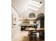 Bright, open kitchen with skylights, modern appliances, breakfast bar, and an adjacent wooden dining table at 11673 W 28Th Ave, Lakewood, CO 80215