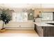 Bright kitchen featuring an island with stone countertop, a scenic mural, and light hardwood floors at 11673 W 28Th Ave, Lakewood, CO 80215