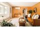 Spacious living room with wood paneling, stylish decor, and comfortable seating at 11673 W 28Th Ave, Lakewood, CO 80215