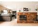 Open concept living space with fireplace, dark wood floors, kitchen and dining area at 11673 W 28Th Ave, Lakewood, CO 80215