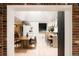 Open-concept living space featuring hardwood floors, a dining table, and a kitchen island at 11673 W 28Th Ave, Lakewood, CO 80215