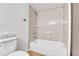 Bright bathroom features a white tiled shower over a tub and neutral wall color at 4661 S Decatur St # 109, Englewood, CO 80110