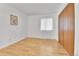 Cozy bedroom featuring natural light from a window, complemented by a spacious closet with wood doors at 4661 S Decatur St # 109, Englewood, CO 80110