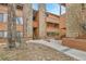 Attractive building exterior with a mix of wood and stone elements, stairs, and landscaping at 4661 S Decatur St # 109, Englewood, CO 80110