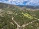 Aerial view of the community showcasing golf course and green spaces at 5846 S Pike Dr, Larkspur, CO 80118