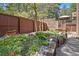 Beautifully landscaped backyard with garden beds and wooden walkway at 5846 S Pike Dr, Larkspur, CO 80118