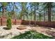 Landscaped backyard with privacy fence and mature trees at 5846 S Pike Dr, Larkspur, CO 80118