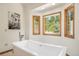 Modern bathroom features a stand-alone tub and large windows with natural light at 5846 S Pike Dr, Larkspur, CO 80118