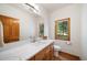 Bright bathroom features modern vanity, fixtures, and serene natural light at 5846 S Pike Dr, Larkspur, CO 80118
