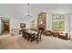Dining area features a stone fireplace, large windows and an elegant chandelier at 5846 S Pike Dr, Larkspur, CO 80118