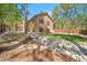 Back exterior view showcasing the backyard and dry creek bed at 5846 S Pike Dr, Larkspur, CO 80118
