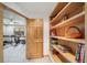 Hallway with bookshelf leading to exercise room at 5846 S Pike Dr, Larkspur, CO 80118