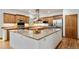 Island kitchen featuring stainless steel appliances, granite countertops, and hardwood floors at 5846 S Pike Dr, Larkspur, CO 80118