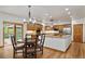 Open-concept kitchen with custom wood cabinetry and granite countertops at 5846 S Pike Dr, Larkspur, CO 80118