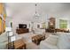 A spacious living room features a stone fireplace and large windows overlooking the yard at 5846 S Pike Dr, Larkspur, CO 80118