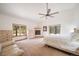 Spacious main bedroom with fireplace, sitting area, and large windows at 5846 S Pike Dr, Larkspur, CO 80118