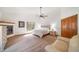 Tranquil main bedroom with fireplace, ceiling fan, and ample natural light at 5846 S Pike Dr, Larkspur, CO 80118