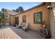 Side porch with chairs and table, perfect for relaxing outdoors at 5846 S Pike Dr, Larkspur, CO 80118