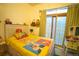 Bright bedroom with playful decor and natural light streaming in through a sliding glass door at 3732 N Franklin St, Denver, CO 80205