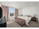 Bright bedroom with large window, neutral carpet, and a comfortable bed with white bedding at 2127 Alcott Way, Broomfield, CO 80023