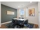 Elegant dining room with modern table, stylish chairs, artwork, and natural light at 2127 Alcott Way, Broomfield, CO 80023