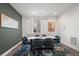 Cozy dining room with a contemporary table, blue chairs, and natural lighting at 2127 Alcott Way, Broomfield, CO 80023