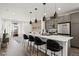 Modern kitchen and open-concept living area with stainless steel appliances and natural light at 2127 Alcott Way, Broomfield, CO 80023