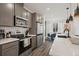 Well-appointed kitchen with stainless steel appliances, a large island, and an adjacent dining area at 2127 Alcott Way, Broomfield, CO 80023