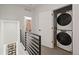 Upstairs laundry room features a stacked washer and dryer and bedroom views at 2127 Alcott Way, Broomfield, CO 80023