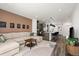 Open-concept living room with modern furniture, a kitchen island, and stylish decor at 2127 Alcott Way, Broomfield, CO 80023