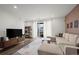 Bright living room with a comfortable sectional sofa, entertainment center, and access to a balcony at 2127 Alcott Way, Broomfield, CO 80023