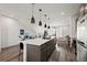 Open-concept living space with a kitchen island, living room area, and modern decor at 2127 Alcott Way, Broomfield, CO 80023