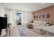 Comfortable living room with a sectional sofa, balcony access, and stylish modern decor at 2127 Alcott Way, Broomfield, CO 80023