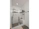 Modern tiled shower with glass doors, built-in bench, and mosaic accent tile at 2127 Alcott Way, Broomfield, CO 80023
