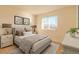 Bedroom with gray bed frame and neutral decor at 2131 Coronado Pkwy # A, Denver, CO 80229