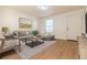 Bright living room with gray sectional sofa and wood-look floors at 2131 Coronado Pkwy # A, Denver, CO 80229