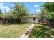 The backyard features a shed, lawn, garden beds, and a walking path at 1160 S Steele St, Denver, CO 80210