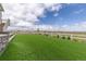 Expansive backyard featuring a lush lawn, white fence, and tasteful landscaping is perfect for recreation and relaxation at 17851 Herrera Dr, Parker, CO 80134