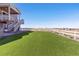 Large backyard with a manicured lawn and white vinyl fencing offers plenty of space to entertain or relax at 17851 Herrera Dr, Parker, CO 80134