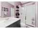 A charming bathroom with a lavender wall, a standing shower, and a sink at 17851 Herrera Dr, Parker, CO 80134