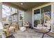 Stylish covered patio with cozy seating, hanging chair, and sliding glass doors for seamless indoor-outdoor living at 17851 Herrera Dr, Parker, CO 80134