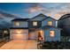 Charming two-story home with a three-car garage, well-manicured lawn, and inviting front porch at 17851 Herrera Dr, Parker, CO 80134