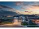 Charming two-story home with a well-manicured front yard and attached two car garage at dusk at 17851 Herrera Dr, Parker, CO 80134