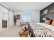 Bright main bedroom with modern decor, bright light and sliding barn door to ensuite bathroom at 17851 Herrera Dr, Parker, CO 80134