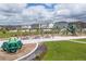 A vibrant neighborhood playground with various play structures and picnic benches, set in a green space at 17851 Herrera Dr, Parker, CO 80134