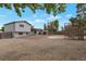 Spacious backyard showcasing a large gravel area and a unique elevated wooden structure at 2493 S Kalispell Cir, Aurora, CO 80013