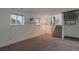 Basement area with carpeted floors, windows, and stairs leading up to the next level at 2493 S Kalispell Cir, Aurora, CO 80013